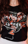 Close up on Washed Black slightly slouchy crew neck T Shirt, with hand painted, multicolored "Influence Change" graphic.