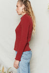 Merlot long sleeve top has fitted body and sleeves with collar and button placket.