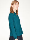 Kingfisher Blue top with twist neck slit detail and long cuffed sleeves.