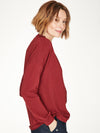 Ruby Red top with twist neck slit detail and long cuffed sleeves.