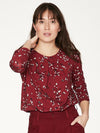 Ruby Red relaxed fit long sleeve top, with pleat detailing at front neckline and shoulder. Features a hand painted floral print.